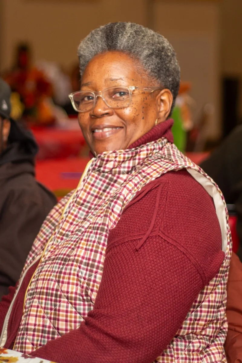 Portrait of a smiling woman at a Foxy Fran's community event
